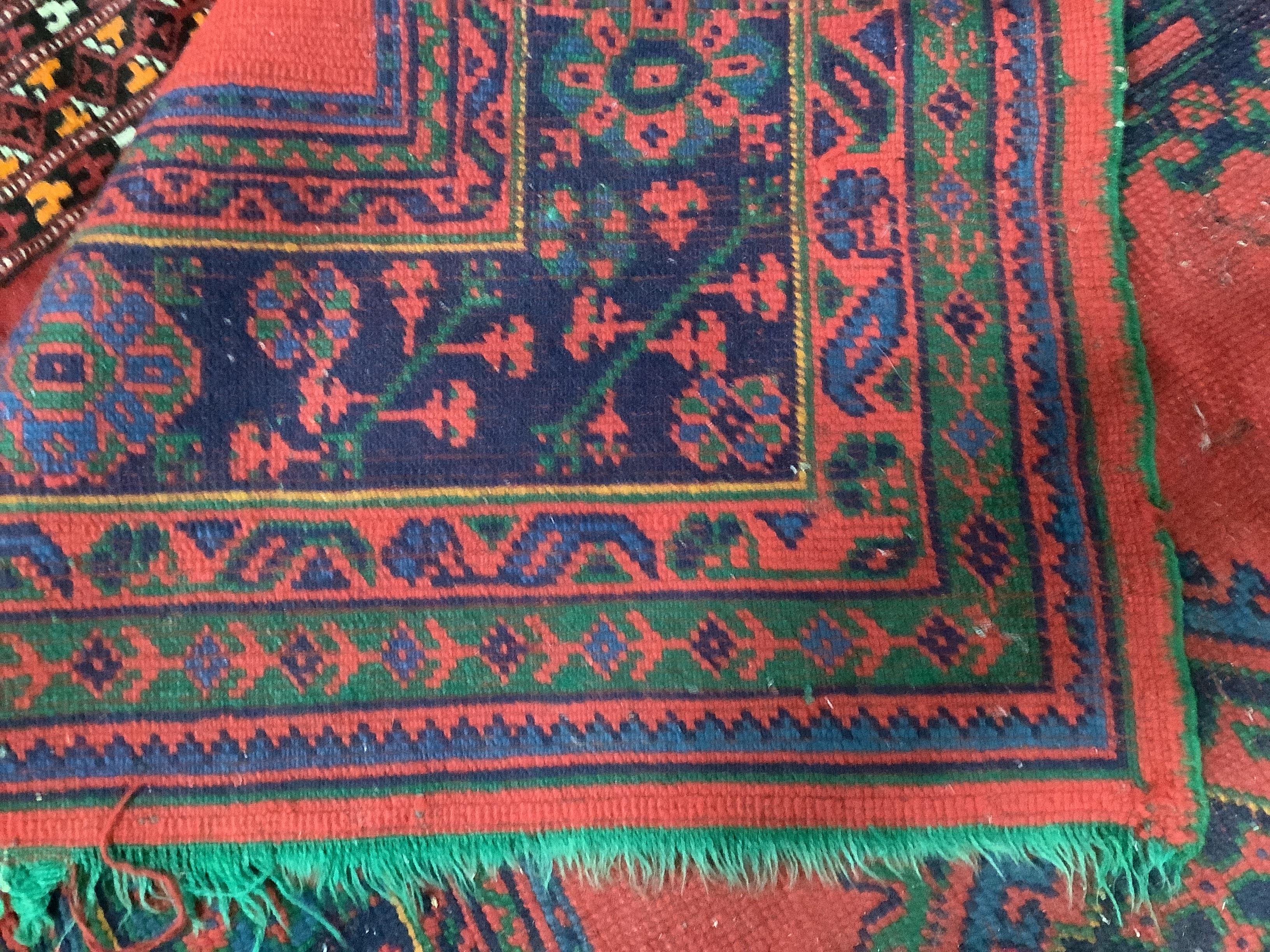 A Turkish red ground carpet, 350 x 278cm